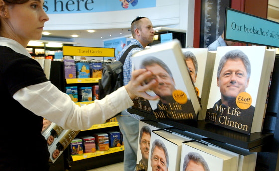 An employee at a central London bookstore replenishes a display holding former President Bill Clinton's new autobiography, “My Life,"” on Tuesday.