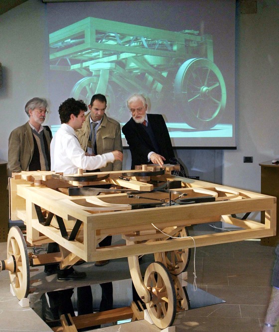 Journalists look at a wooden model of a car designed by Renaissance genius Leonardo da Vinci on display at an exhibition in Florence's Science Museum, Italy. Florentine engineers have built three new machines, based on Leonardo's plans, that&nbsp;couldn't have functioned using the materials available during his life.