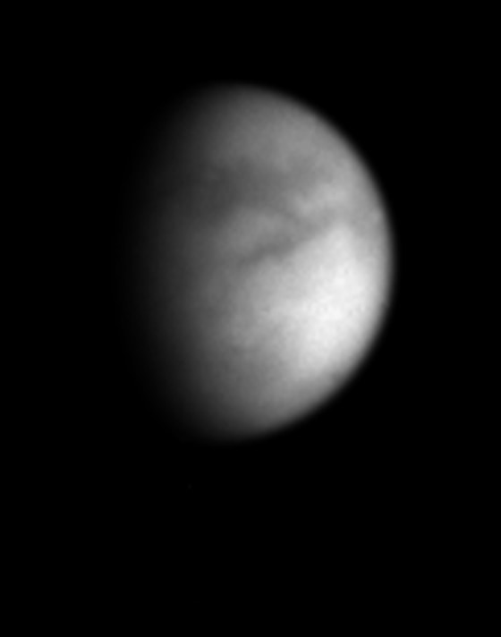 Cassini's latest picture of Titan reveals what appear to be bright and dark regions on the surface in unprecedented detail. The picture was taken using a filter designed to cut through the thick haze surrounding the Saturnian moon.