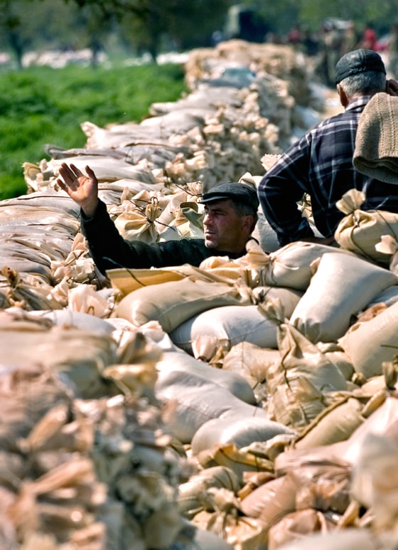Sandbags are piled up Thursday in Manastire, Romania, where some areas have already seen Danube flooding.