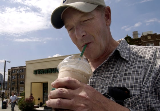 Gary Lass takes a sip from his grande mocha Frappuccino with whipped cream that he bought from a Starbucks in Seattle June 25.