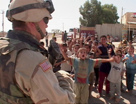Soldier with local kids just outside of the Forward Operating Base Eagle, Sadr City, Iraq. 