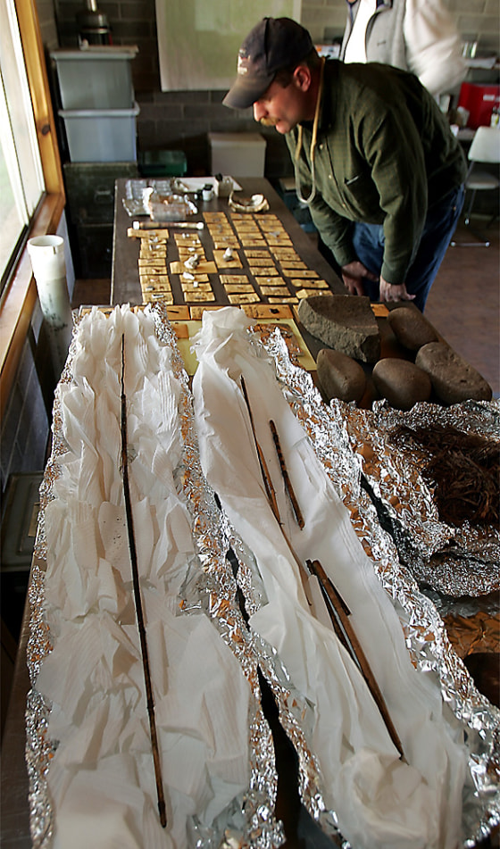 Journalists look at pottery pieces, arrowheads, beads and other artifacts Wednesday in the Range Creek area southeast of East Carbon City, Utah.