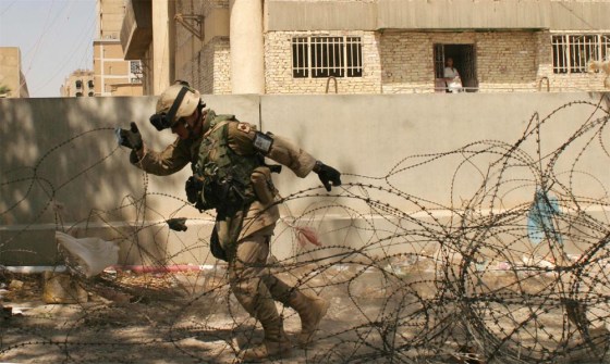 In downtown Baghdad, Sgt. Joseph Watts of Van Buren, Ark., clears razor wire around a U.S. military check point.