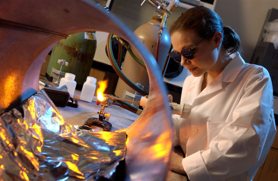 Alfred University graduate student Melodie Schmitt makes experimental glass microspheres — microscopic spheres that researchers are testing as a way to store hydrogen for fuel cell cars.