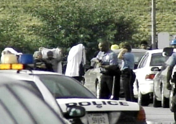 Police interview witnesses Friday outside the ConAgra plant in Kansas City, Kan.