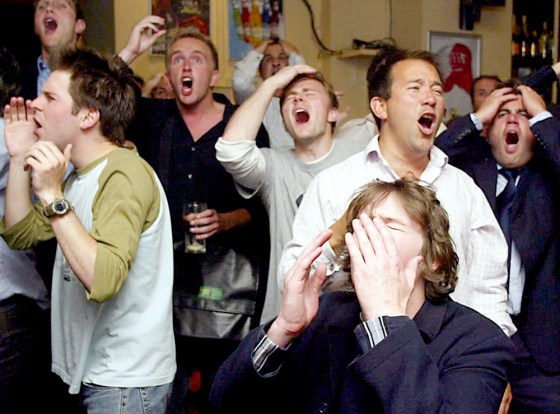 English fans react as they watch the Euro 2004 quarterfinal soccer match between Portugal and England on the big screen at the Elusive Camel pub in Victoria, London last week.