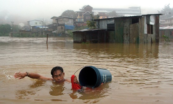 A FILIPINO RESIDENT WADES ACROSS FLOODED AREA AFTER TYPHOON MINDULLE HIT BAGUIO CITY