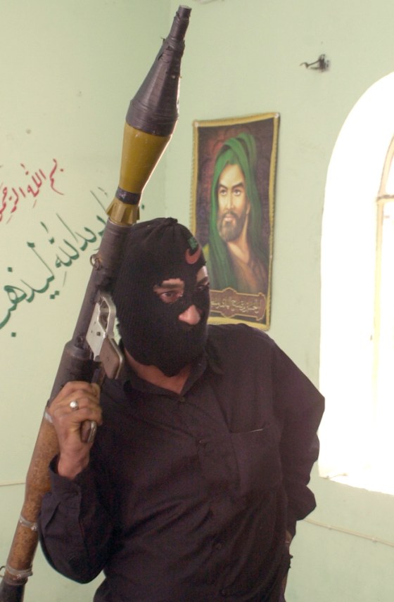 A militant loyal to rebel cleric Muqtada al-Sadr stands in a home in Baghdad's Sadr City neighborhood on June 28.