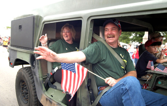 Thomas Hamill receives a warm welcome during his hometown's Fourth of July parade on Saturday in Macon, Miss.