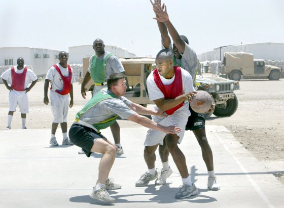 Teams from the U.S. Air Force 732 Expeditionary Civil Engineering Squadron, in red and white, and the U.S. Army 28th Signal Battalion, in green, play 3-on-3 basketball at Camp Victory near Baghdad, on Sunday.