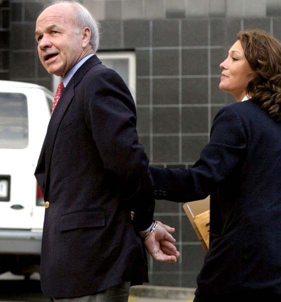 Former Enron CEO Kenneth Lay, left, is led into Federal Court by law enforcment officers in Houston Thursday.