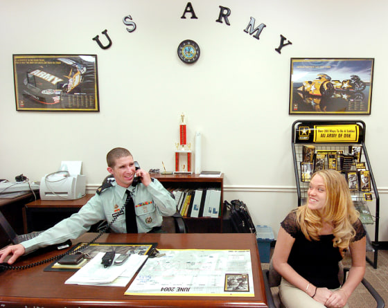 Army Sgt. Justin chats on the phone as Cecelia Haslacker, one of the new recruits, pays him a visit. 