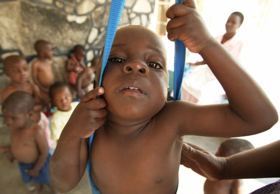 ZIMBABWEAN HIV/AIDS ORPHANS ARE WEIGHED DURING A WEEKLY MEDICAL CHECK AT AN ORPHANAGE