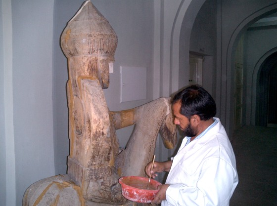 Shairazuddin Saifi, Director of the Kabul Museum restoration department, works on an antique horse.