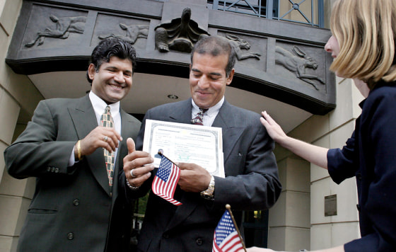 NEGATIVE# josephm 157645--SLUG-ME-AFGHANS--DATE-07/15/2004--LOCATION-U.S. District Court, 401 Courthouse Square, Alexandria, Virginia--PHOTOGRAPHER-MARVIN JOSEPH/TWP--CAPTION-Photos for a story of two deaf brothers from Afghanistan, one receives U.S. citizenship today while the other waits his turn. PICTURED, Laura Burdick of Catholic Legal Immigration Network(far right) congratulates, Satar Reangber(CQ)(center) became a U.S. citizen today after years of back and forth with the INS over his disability. Salam Reangber(CQ)(far left) also congratulates his brother. StaffPhoto imported to Merlin on Thu Jul 15 17:39:05 2004