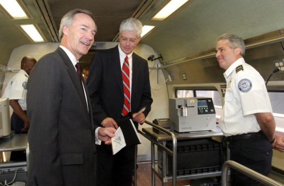 Asa Hutchinson, left, Undersecretary for Border and Transportation Security, and Stephen Korta, center, Connecticut Department of Transportation Commissioner, tour a rail car equipped with technology to screen baggage for explosives on Thursday in New Haven, Conn. 