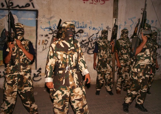 Palestinian gunmen of the Al Aqsa Martyrs Brigades gather during a demonstration against Yasser Arafat's appointment of his cousin as head of security services Sunday at the Rafah refugee camp.
