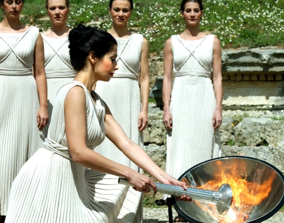 Greek actresses dressed as high priestesses take part in a rehearsal for the official flame lighting ceremony at Ancient Olympia earlier this year. In the ancient games, contestants roasted meat and offerings in a sacred flame.