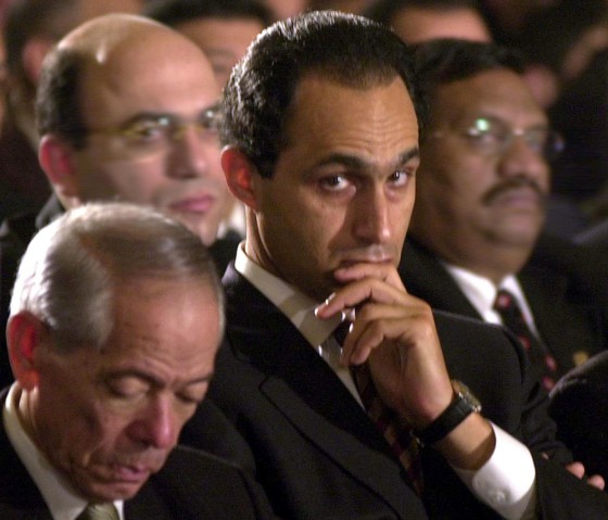Egyptian President Hosni Mubarak's eldest son, Gamal, center, attends a midnight mass on Coptic Christmas Day last year.