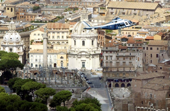 An Italian police helicopter patrols the sky over the Roman Forum in Rome