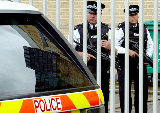 Armed police stand guard at Belmarsh Magistrates Court in London on Wednesday as terror suspects appear before the court inside.