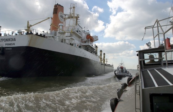 Two pilot boats, at right, close in on the Gulf of Mexico-bound freighter Calliroe Patronicola on the Mississippi River.
