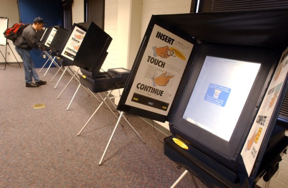 A man places his vote at a touch screen voting station in Riverside, Calif., in this March 1, 2004 photo. The company who built the machines refused to hand over technical information when a recount was ordered.