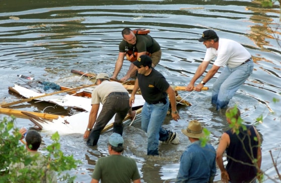 WORKERS RETRIEVE HORSE TRAILER FROM BRIDGE COLLAPSE SCENE IN WEBBERS FALLS