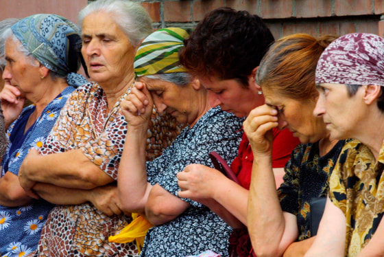 Local women wait for news as they sit near the school seized by attackers in Beslan, in the Russian province of North Ossetia, on Wednesday.