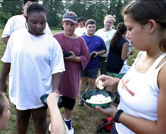 Tired campers Kelsey McDaniel and Ben Farber, foreground, lead a group up the trail during a hike.