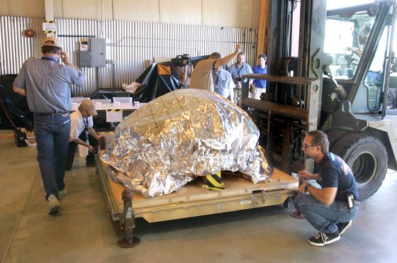The Genesis spacecraft's payload is brought into a hangar on a forklift for examination Wednesday at the Dugway Proving Ground in Utah.