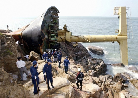 Japanese rescue workers search for missing crew members of an Indonesian-registered cargo ship stranded on Kasado Island