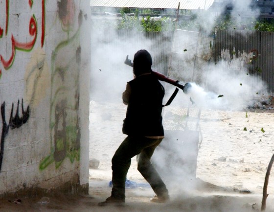 A Palestinian militant launches a rocket-propelled grenade toward Israeli Army vehicles in the Jebalya refugee camp, outside Gaza City, on Thursday.
