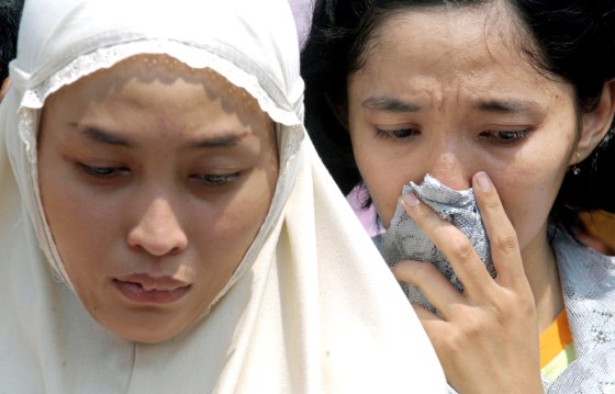 Relatives mourn Rina Dewi Puspita following her burial, on Friday, a day after she was killed in a bomb explosion outside the Australian Embassy in Jakarta, Indonesia.