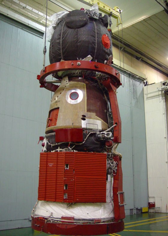 A Soyuz TMA spaceship is shown under construction in Russia. A mishap during the testing of such a craft, apparently involving an explosive bolt in the Soyuz docking module, caused a delay in its scheduled launch to the international space station.