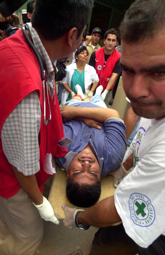 Rescue workers carry an inmate to be treated after a riot broke out at the La Esperanza penitentiary in San Salvador, El Salvador, in August. 