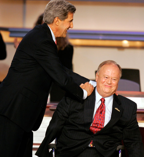 John Kerry greets former Senator Cleland on stage at Democratic National Convention