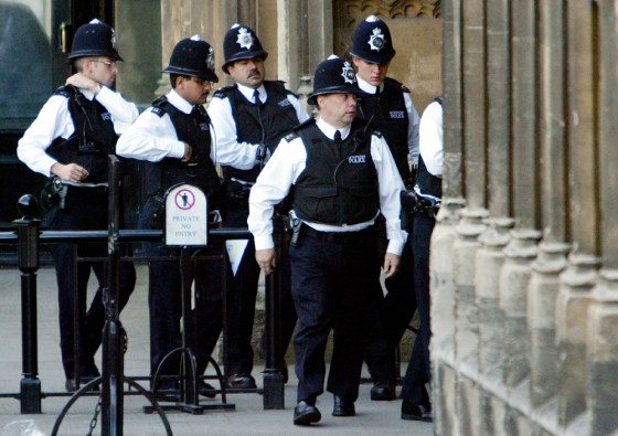 Police officers enter the House of Commons in central London