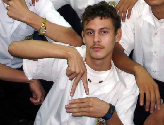 The inverted-V sign being demonstrated by this schoolboy is one of the new signs for "Nicaragua."