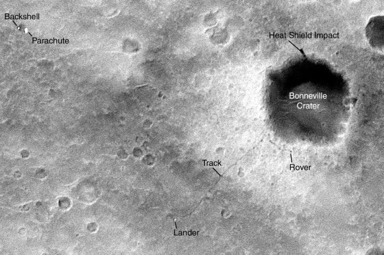 An image acquired by the Mars Global Surveyor and released Monday shows a dark dot identified as the rover Spirit next to giant Bonneville Crater and the thin dark line of its tracks leading back to its lander.
