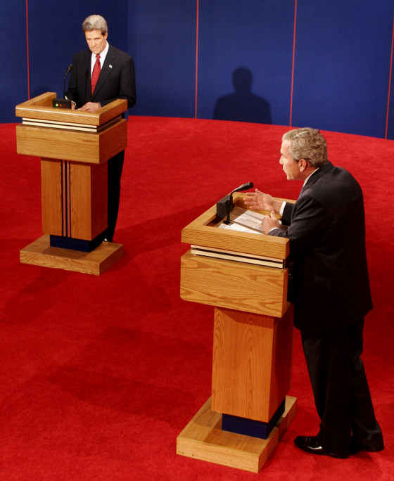 Sen. John Kerry, left, listens as President Bush answers a question Thursday.