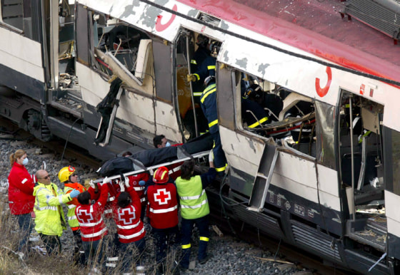 RED CROSS HELPERS CARRY BOMB VICTIM OF FROM TRAIN OUTSIDE MADRID TRAIN STATION