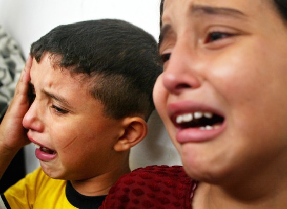 The children of Palestinian school teacher Maher Zagoot weep during his funeral in the Jebaliya refugee camp in the northern Gaza Strip on Sunday. Zagoot was killed in an Israeli missile strike earlier in the day.