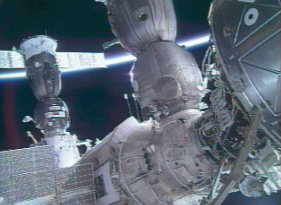 A Russian Soyuz spacecraft (left) carrying two cosmonauts and an American astronaut docks with the international space station in October.