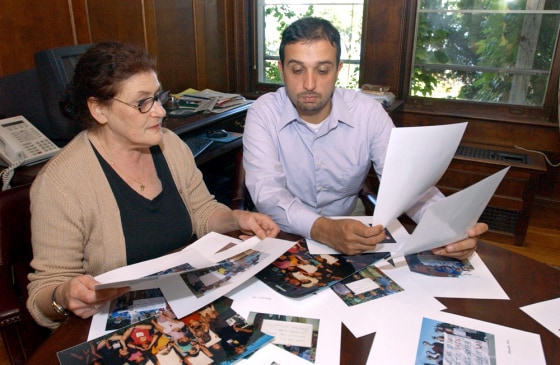 Jennifer Hyman, left, and Hossein Alizadeh sort through photos that will be used in the organization's 'Iraq Photo Project', in Nyack, N.Y.