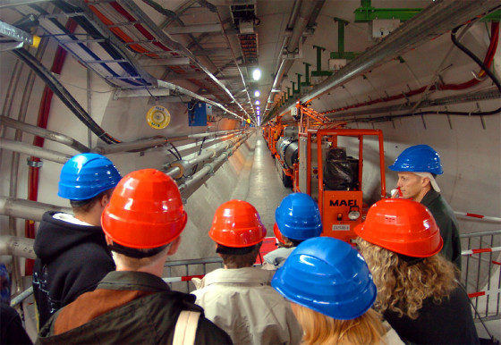 Visitors look into the 27km long underground ring LHC during the CERN's 50th anniversary Open day in Geneva