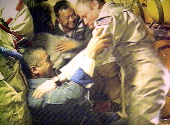 Astronauts Sharipov, Padalka, Chiao, Shargin and Fincke are seen in the screen at the space control centre in Korolyov satellite town outside Moscow