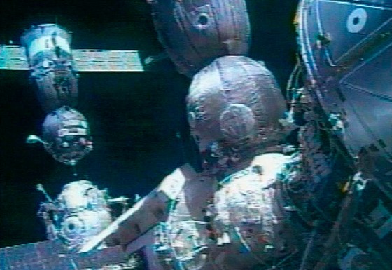 The Soyuz TMA-5, top left corner, is seen moments before docking to the International Space Station in this image made from TV, on Saturday. The Soyuz's U.S.-Russian crew had to switch off autopilot after the approach speed became dangerously high and docked the ship in a manual mode.