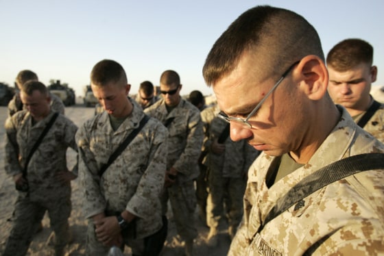 Marine Sgt. Tim S. Carter, a Reserve Marine and military policeman with the 1st Force Service Support Group's 6th Motor Transport Battalion at Camp Taqaddum, Iraq, joins his fellow Marines in prayer before leaving on a supply convoy to&nbsp;Ramadi&nbsp;on&nbsp;Sept. 17. 